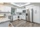 Bright kitchen featuring white cabinets, granite countertops, and stainless steel appliances at 8039 E Madero Ave, Mesa, AZ 85209