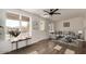 Cozy living room with ample natural light, modern furnishings, and backyard access at 8039 E Madero Ave, Mesa, AZ 85209