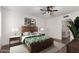 Comfortable main bedroom featuring a ceiling fan, neutral decor and an ensuite bathroom at 8039 E Madero Ave, Mesa, AZ 85209
