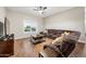 Living room with large sectional sofa and wood flooring at 851 E Birchwood Pl, Chandler, AZ 85249