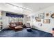 Living room with brown leather couch and blue carpet at 8715 E Via De Viva --, Scottsdale, AZ 85258