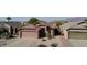 Single-story house with a two-car garage, desert landscaping, and mountain views in the background at 8944 E Red Mountain Ln, Gold Canyon, AZ 85118