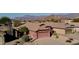 Aerial view of a charming single-story house with a two-car garage, desert landscaping, and mountain views at 8944 E Red Mountain Ln, Gold Canyon, AZ 85118