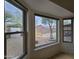 View from a window overlooking a private backyard with mature trees at 8944 E Red Mountain Ln, Gold Canyon, AZ 85118