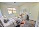 Minimalist bedroom with tile floors, sleek white furniture, and colorful accents offering a modern feel at 8944 E Red Mountain Ln, Gold Canyon, AZ 85118