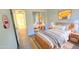 Cozy bedroom with wooden bed frame, striped rug, and mirrored closet providing ample storage space at 8944 E Red Mountain Ln, Gold Canyon, AZ 85118