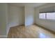 Bright bedroom with light wood flooring and a window with blinds at 8944 E Red Mountain Ln, Gold Canyon, AZ 85118