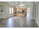 Well-lit kitchen open to the living area, featuring a dark countertop island, and warm wood cabinetry for ample storage space at 8944 E Red Mountain Ln, Gold Canyon, AZ 85118