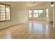 Spacious living room with wood flooring, and multiple windows flooding the area with natural light offering a bright living space at 8944 E Red Mountain Ln, Gold Canyon, AZ 85118