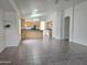 Spacious living area adjacent to the kitchen, featuring tiled floors and neutral walls for a comfortable and bright atmosphere at 8944 E Red Mountain Ln, Gold Canyon, AZ 85118