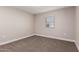 Simple bedroom with carpet and a window at 9507 W Burns Dr, Sun City, AZ 85351