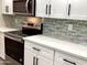 Close-up of kitchen countertops, backsplash, and modern cabinetry at 9507 W Burns Dr, Sun City, AZ 85351