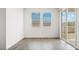 Bright bedroom with wood-look tile flooring and sliding glass door access to patio at 9868 S Caballo Dr, Apache Junction, AZ 85120