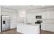 Spacious kitchen with island, stainless steel appliances, and white cabinets at 9868 S Caballo Dr, Apache Junction, AZ 85120