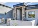 Modern home exterior with stone accents and covered entryway at 103 E Quartz Rock Rd, Phoenix, AZ 85085