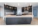 Modern kitchen with large island, dark cabinetry, and breakfast bar at 103 E Quartz Rock Rd, Phoenix, AZ 85085
