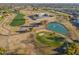 Aerial view of a golf course community with a pond and clubhouse at 10632 W Roundelay Cir, Sun City, AZ 85351