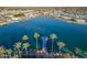 Aerial view of lakefront community with palm trees and private docks at 10632 W Roundelay Cir, Sun City, AZ 85351