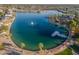 Aerial view of lake with fountain, dock, and surrounding community at 10632 W Roundelay Cir, Sun City, AZ 85351