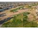 Aerial view of a golf course with palm trees and a putting green at 10632 W Roundelay Cir, Sun City, AZ 85351