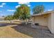 Patio area with seating and a large orange tree in the backyard at 10632 W Roundelay Cir, Sun City, AZ 85351