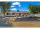 Covered patio with seating area and a lush orange tree in the background at 10632 W Roundelay Cir, Sun City, AZ 85351