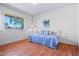 Bright bedroom with wood floors, a daybed, a ceiling fan and a sunlit window at 10632 W Roundelay Cir, Sun City, AZ 85351