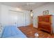 Bedroom with daybed, wood floors, and double door closet at 10632 W Roundelay Cir, Sun City, AZ 85351