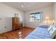 Bedroom with daybed, wood floors, and double door closet at 10632 W Roundelay Cir, Sun City, AZ 85351