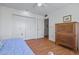 Bedroom featuring a daybed, closet doors, wood floors, and wood dresser at 10632 W Roundelay Cir, Sun City, AZ 85351