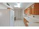 Bright kitchen features wood cabinets, tile flooring, and modern appliances at 10632 W Roundelay Cir, Sun City, AZ 85351
