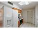 White appliances and wood cabinets in this galley-style kitchen at 10632 W Roundelay Cir, Sun City, AZ 85351