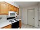 Kitchen features wood cabinets, stove, and microwave at 10632 W Roundelay Cir, Sun City, AZ 85351