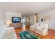 Living room with hardwood floors, light walls, and comfortable seating at 10632 W Roundelay Cir, Sun City, AZ 85351