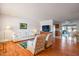 Bright living room with hardwood floors and a view into the dining area at 10632 W Roundelay Cir, Sun City, AZ 85351