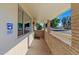 Covered porch with brick columns and tile flooring at 10632 W Roundelay Cir, Sun City, AZ 85351