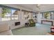 Sunroom features multiple windows, comfy seating, and access to backyard at 10632 W Roundelay Cir, Sun City, AZ 85351