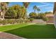 Landscaped backyard with putting green at 10710 E Voax Dr, Sun Lakes, AZ 85248