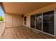 Spacious patio with wood-look tile flooring, sliding glass doors, and a storage closet at 11048 N 28Th Dr # 247, Phoenix, AZ 85029