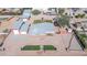 Aerial view of house, detached garage, and landscaped yard with artificial turf at 11120 E Grove St, Mesa, AZ 85208