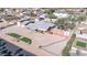 Aerial view of house, detached garage, and a landscaped yard with artificial turf at 11120 E Grove St, Mesa, AZ 85208