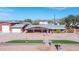 Single-story home with a detached garage and artificial turf in the front yard at 11120 E Grove St, Mesa, AZ 85208