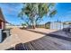 Backyard with mature tree, storage shed, and block wall at 11120 E Grove St, Mesa, AZ 85208