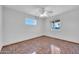 Bright bedroom with tile floors and ceiling fan at 11120 E Grove St, Mesa, AZ 85208