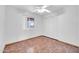 Simple bedroom with tile floors and double closet at 11120 E Grove St, Mesa, AZ 85208