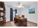 Home office with built-in shelving and wood desk at 11120 E Grove St, Mesa, AZ 85208