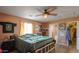 Bedroom with wood bed frame, ceiling fan, and ample closet space at 11865 N Allegro Rd, Maricopa, AZ 85139
