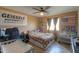 Bedroom with ceiling fan, crib and dresser, and wall decor at 11865 N Allegro Rd, Maricopa, AZ 85139