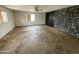 Simple bedroom with wood-paneled accent wall and ceiling fan at 1437 E Hall St, Tempe, AZ 85281