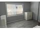 Simple bedroom with gray walls and wood-look floors at 16210 N 32Nd Way, Phoenix, AZ 85032